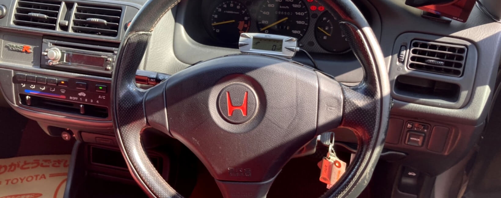 The steering wheel and dash of a Honda Civic Type-R EK9