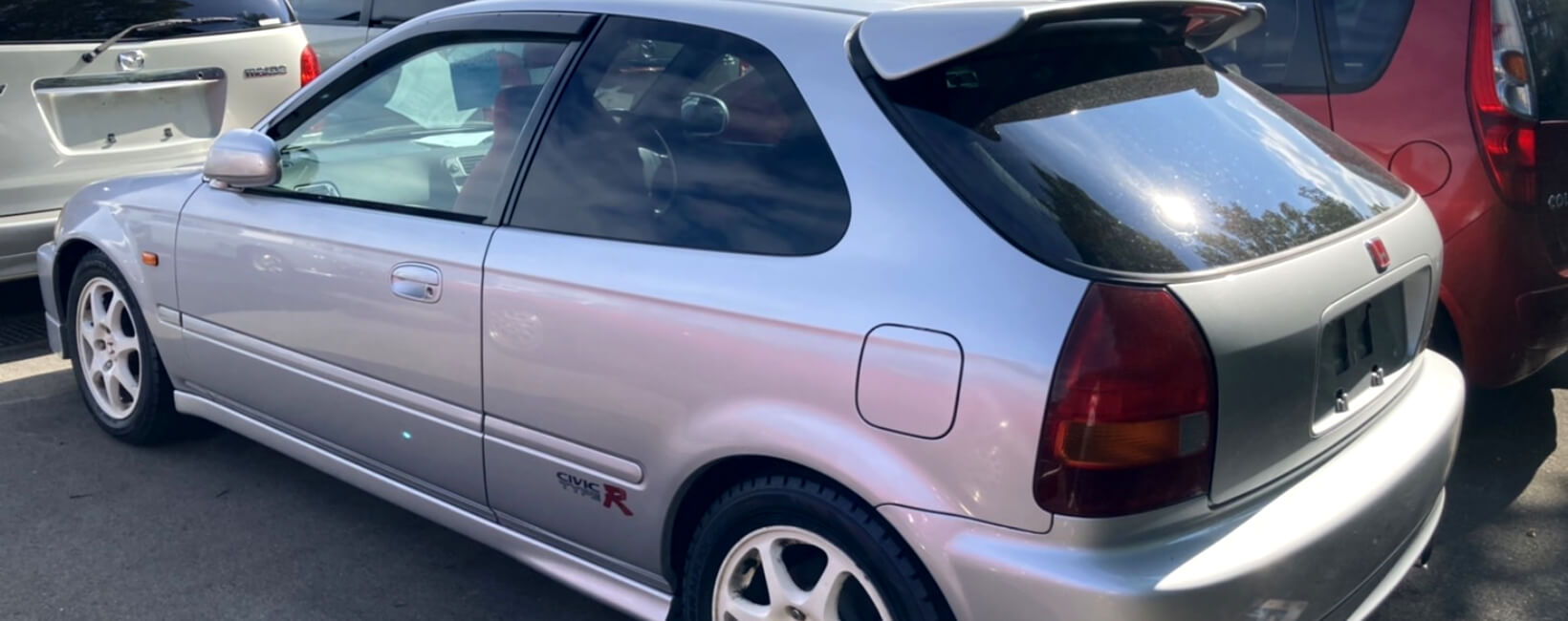 Rear quarter view of a silver Honda Civic Type-R EK9