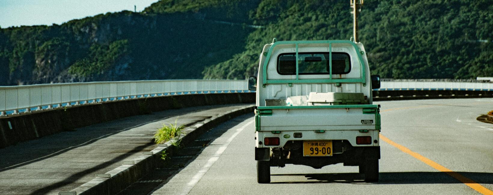 A Suzuki Carry driving on a road in Okinawa Japan