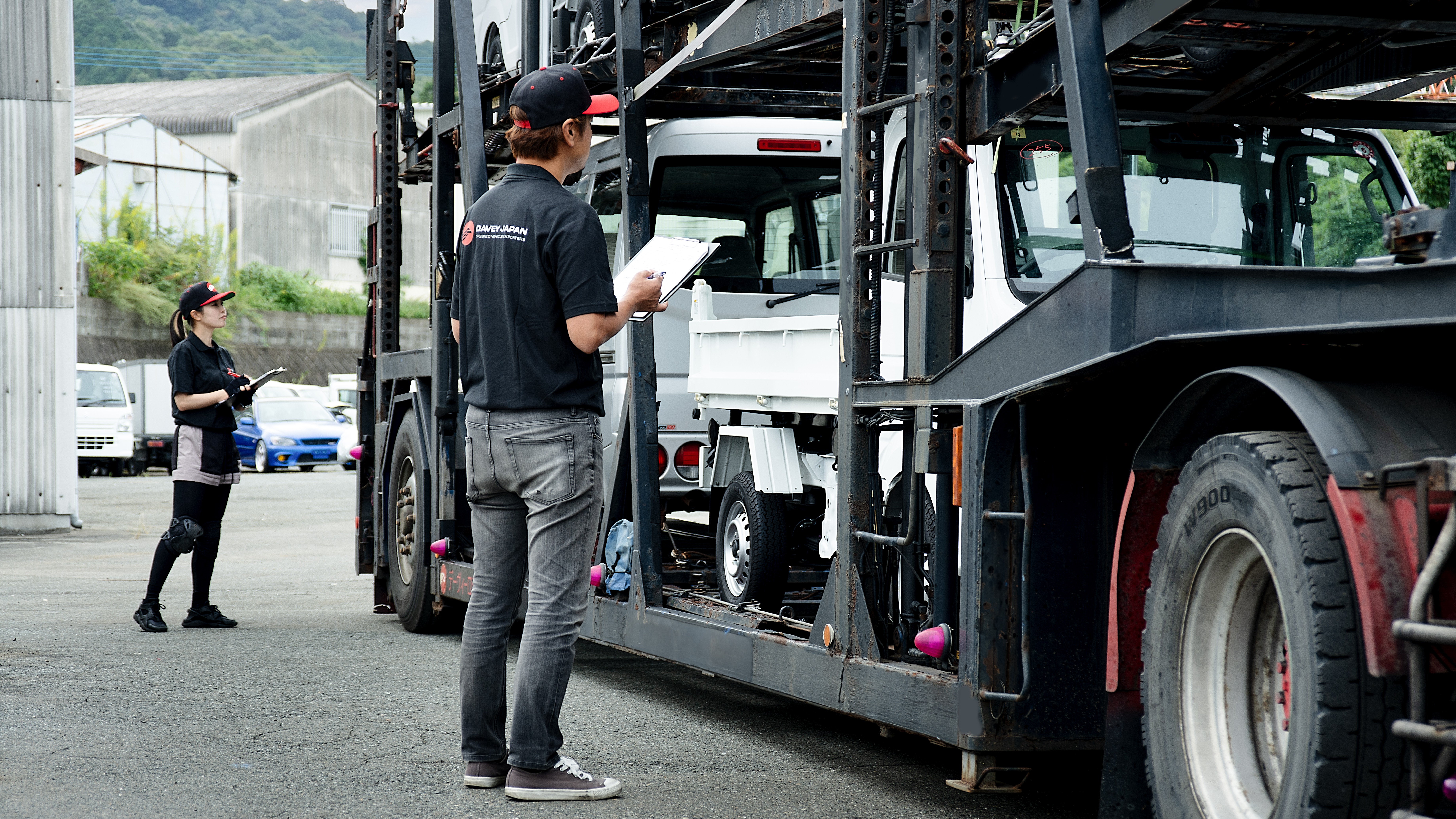 Davey Japan staff inspecting cars loaded on a carrier from an auction house in Japan. 