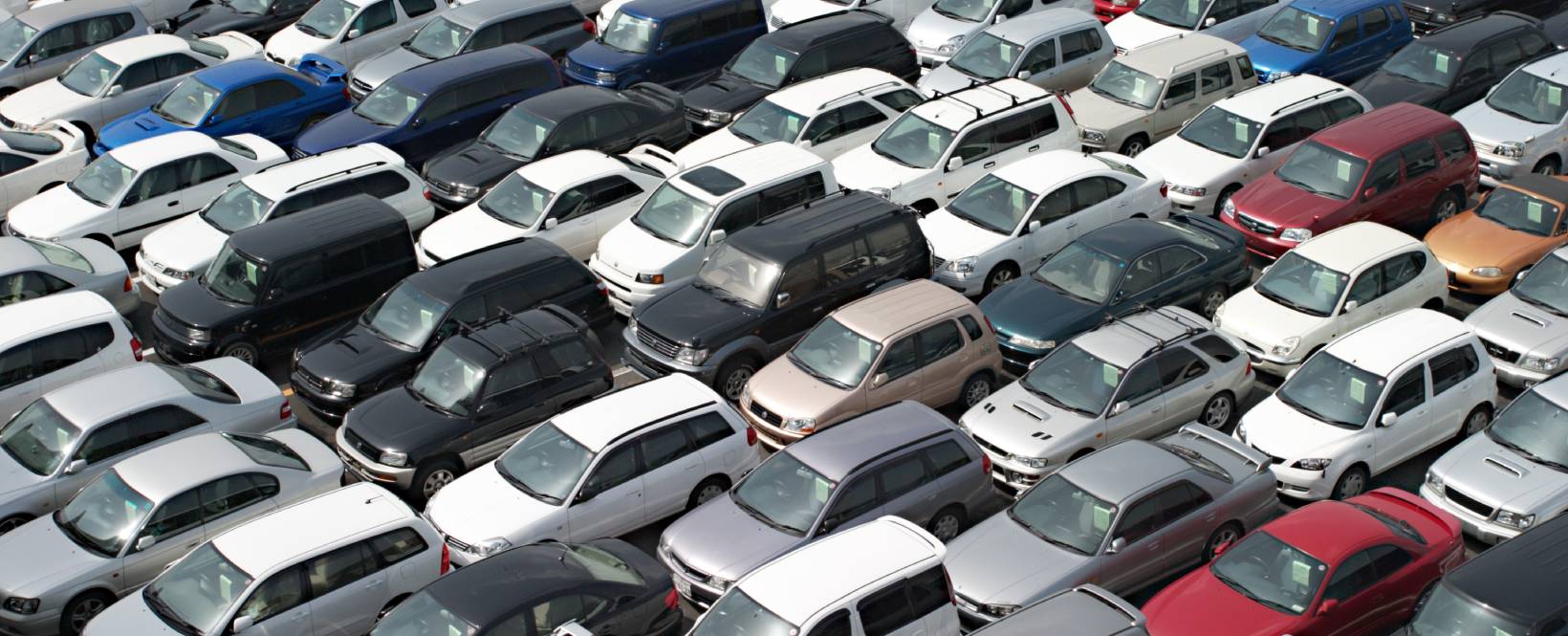 An overhead view of a Japanese imports used car auction yard 